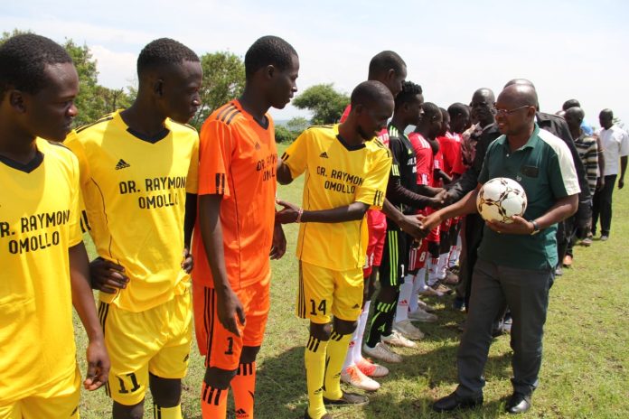 story today interior PS Raymond Omollo representative Michael Odari greets players at Wachara Karungu in Nyatike, Migori county
